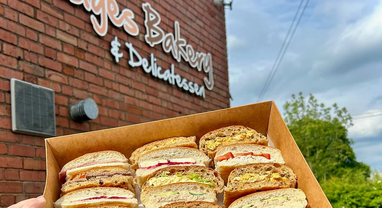 A boxed Wedges Bakery sandwich platter held up outside the Hockley Heath bakery
