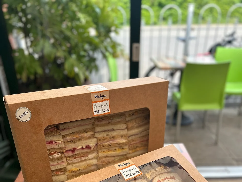 Large and medium Wedges sandwich platters in window-topped boxes, ready for collection
