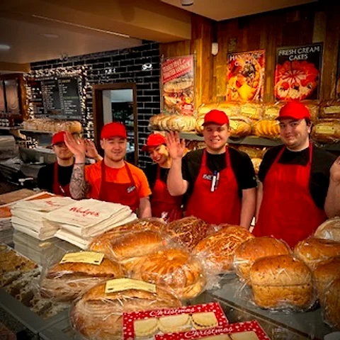 The Wedges counter team behind the bread display at Christmas